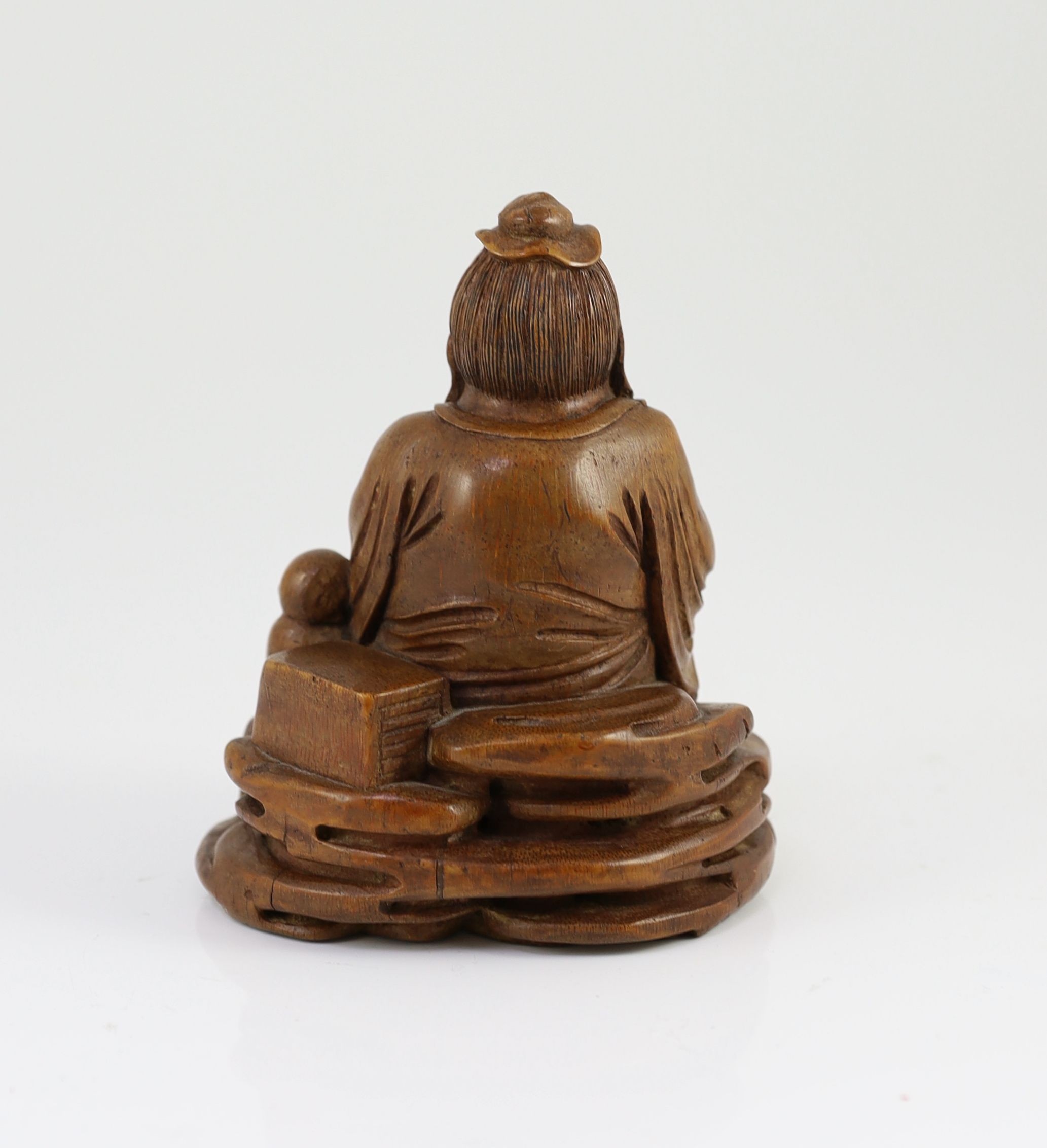 A Chinese carved bamboo figure of a seated sage reading a book, a boy beside him, probably 19th century, 15cm high